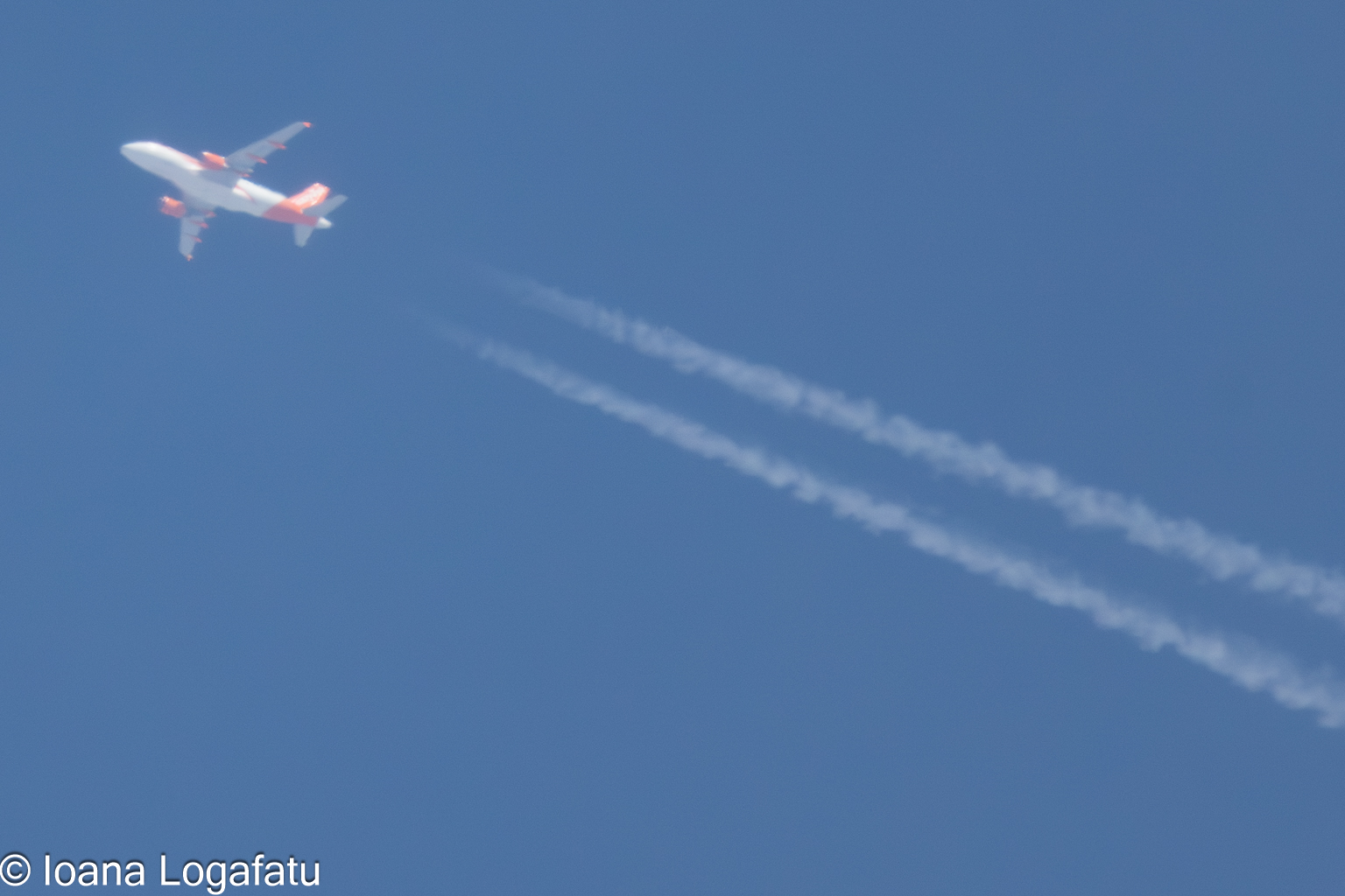 Jet soaring high against a clear blue sky